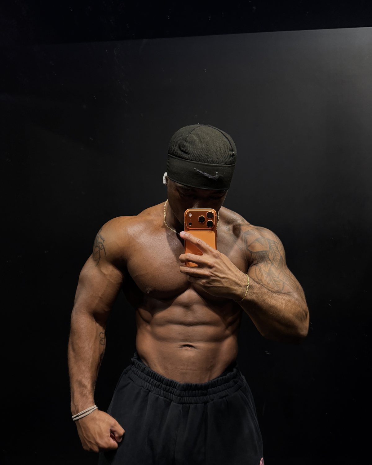 Edward Banks, shirtless in a black beanie, mirror photo